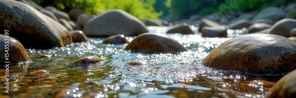Fototapeta Smooth, colorful river rocks tumbling in a clear mountain stream Sunlight glints off the wet stones, creating a tranquil scene Perfect for nature, relaxation, and water themes , scene, vibrant