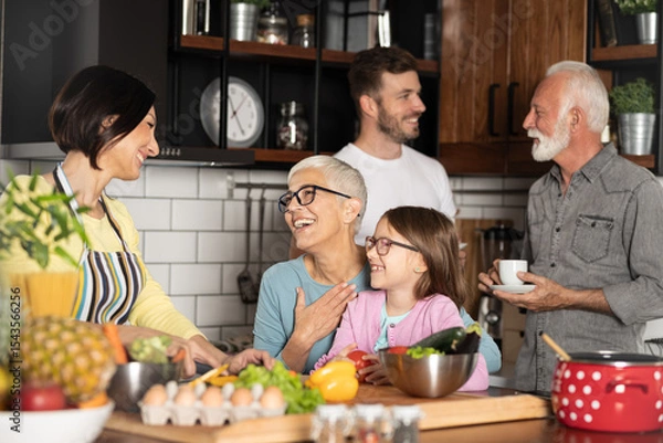 Obraz Cheerful family spending good time together while cooking in kitchen