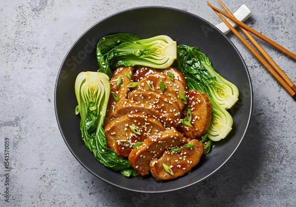 Fototapeta Teriyaki Pork Tenderloin with Bok Choy in a Black Bowl Top View