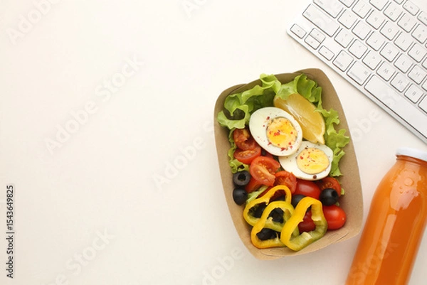 Fototapeta Healthy food. Different meals in containers and foods next to your laptop. Quick snack Space for text