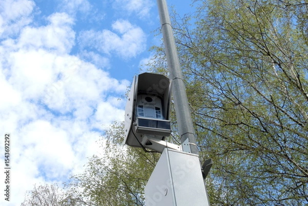 Obraz A surveillance camera hangs on a pole.