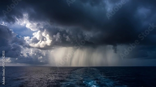 Obraz Dramatic thunderstorm clouds and heavy rainfall over dark ocean horizon