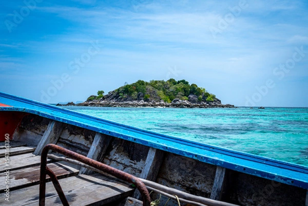 Fototapeta View of a Tropical Island in Clear Blue Waters from a boat in Thailand
