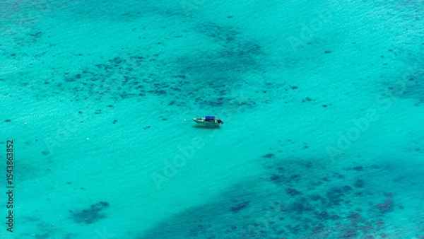 Obraz Aerial View of a Small Boat Floating in Turquoise Tropical Waters near Thailand