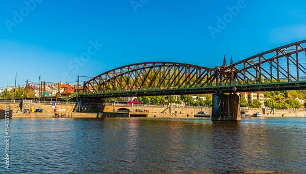 Fototapeta A view from the Vltava river across the Vysehrad Railway Bridge in Prague in springtime