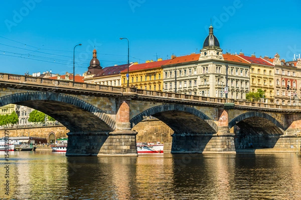 Fototapeta A view from the Vltava river towards the southern side of the Palacke bridge in Prague in springtime
