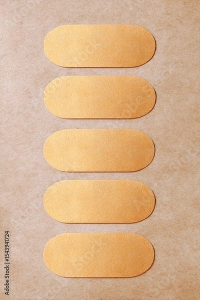 Obraz Gold Oval Labels on Kraft Paper Background