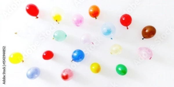 Obraz Vibrant balloons in various colors float against a crisp white backdrop, creating a joyful scene.