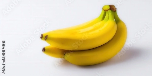 Obraz Close-up of a bunch of bright yellow bananas on a white background.