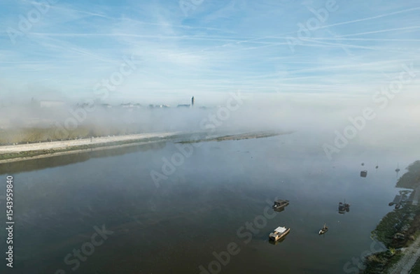 Obraz Experience the magic of the Loire Valley shrouded in morning mist, with tranquil waters reflecting iconic castles like Chambord and Chenonceau