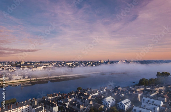 Obraz A stunning aerial perspective captures the enchanting Loire Valley at dawn, where mist envelops the serene riverbanks