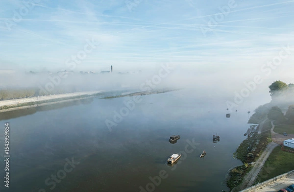 Obraz Experience the mesmerizing beauty of the Loire Valley at dawn, where gentle mists hover over tranquil waters and historic castles emerge amidst lush landscapes