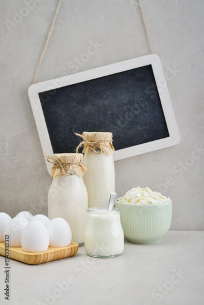 Fototapeta Various dairy products and eggs with framed chalk board