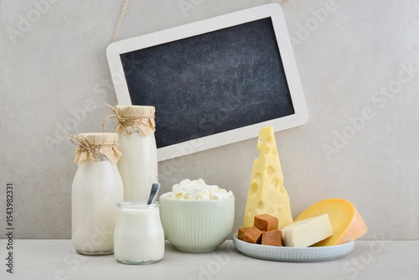 Fototapeta Various dairy products with framed chalk board