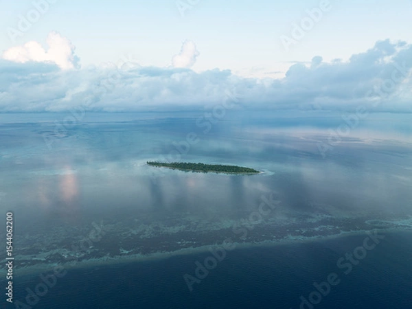 Obraz Evening light illuminates an island within Wakatobi National Park, off the coast of Sulawesi. This area is a popular destination for divers and snorkelers due to its high marine biodiversity.