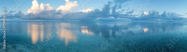 Obraz Evening light illuminates clouds drifting over Wakatobi National Park, off the coast of Sulawesi. This area is a popular destination for divers and snorkelers due to its high marine biodiversity.