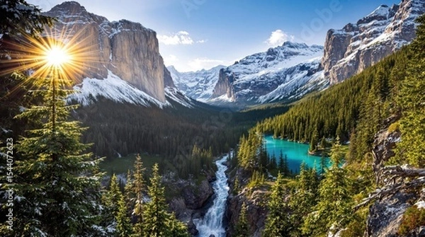 Fototapeta Majestic mountain valley at sunrise, with turquoise lake and cascading waterfall.  Sunlight flares from behind towering peaks