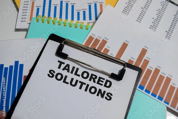 Obraz Concept of Tailored solutions write on paperwork isolated on Wooden Table.