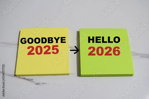 Obraz Concept of Goodbye 2025 to Hello 2026 write on sticky notes isolated on Wooden Table.