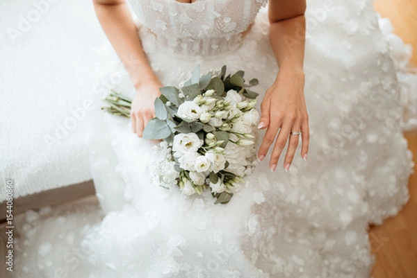 Obraz top down shot of bride holding a bouquet