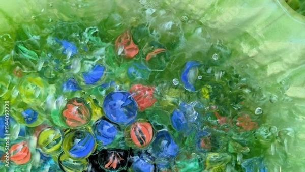 Fototapeta Clear marbles in water - abstract colorful background with glass marbles  
