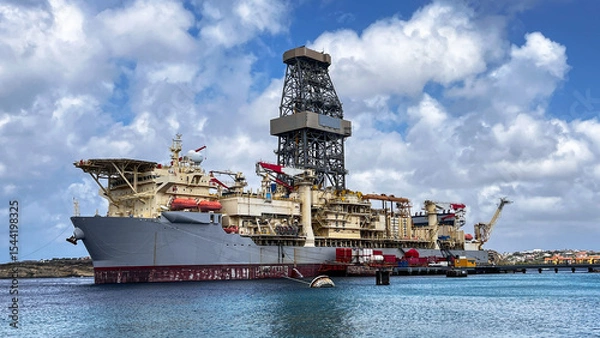 Fototapeta Portrait Drill Ship is called "NOBLE VOYAGER", while standing close to Caribbean Island Curacao. Ship is drilling for the oil and gas and is consider as  modern, versatile, and technically advanced 
