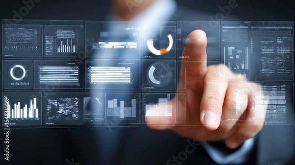 Fototapeta A person interacts with a futuristic transparent digital interface displaying various charts, graphs, and data analytics.