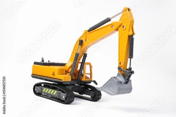Fototapeta A miniature model of a yellow excavator on isolated on white background. Highlighting construction equipment. Yellow excavator model toy
