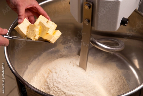 Obraz Put butter in a dough mixer.