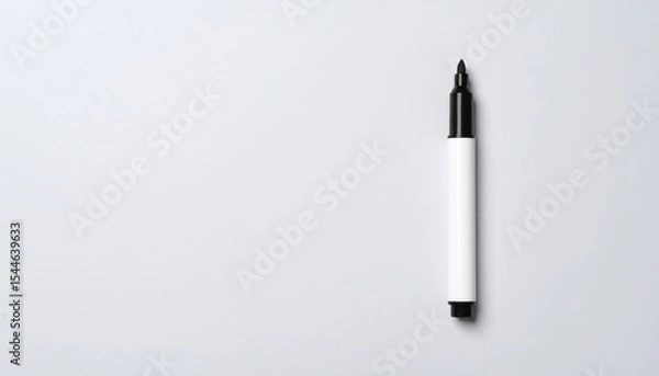 Fototapeta Marker Pen on White: A single black marker on a clean white background with copy space. Concepts: writing, drawing, ideas, office, art.