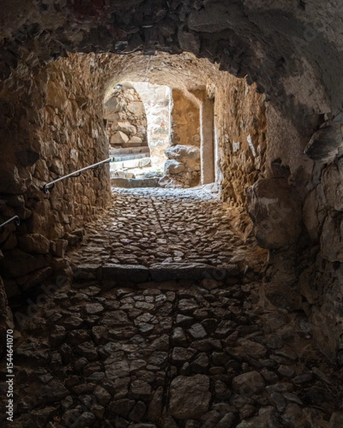 Fototapeta A maze of stone, cobbled, passageways connect the houses in the medieval hilltop village of Sant'Antonino in the Balage region of the Mediterranean island of Corsica