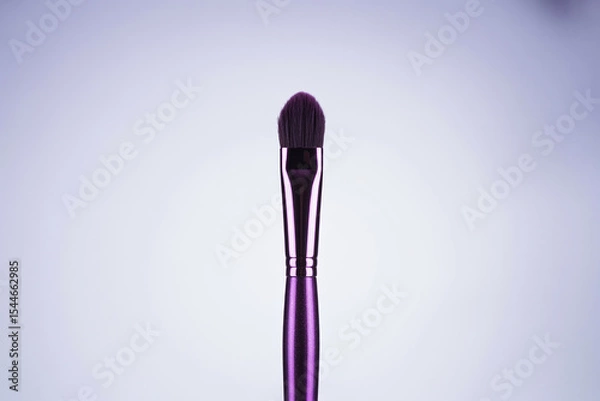 Fototapeta Purple Blending Eyeshadow Brush with Soft Bristles for Makeup Application on a White Background