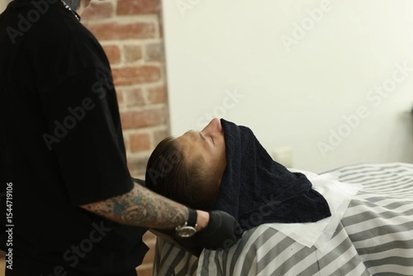Fototapeta Professional barber working with client in barbershop, closeup