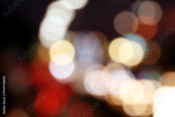 Fototapeta Abstract Night Lights: A mesmerizing collection of blurred orbs of golden and white light dances against a dark backdrop, creating a dreamy.