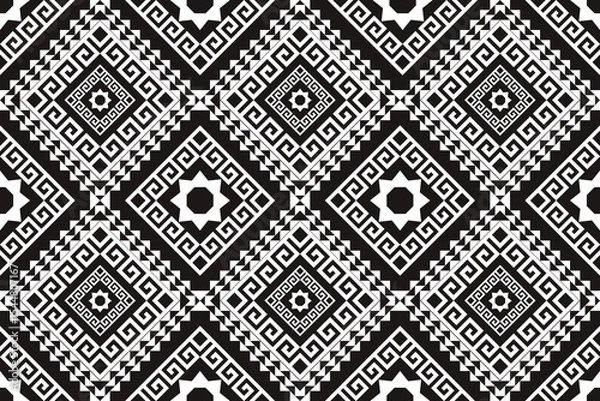 Fototapeta A bold black and white seamless pattern inspired by traditional geometric and ethnic motifs. Featuring sharp diamond shapes, spiral elements, and symmetrical pixel details, this design is ideal for in