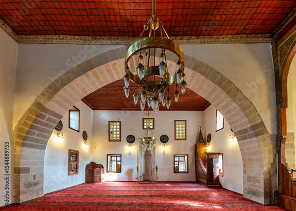 Fototapeta Inside Shems-i Tebrizi Mosque and Tomb, the exquisite architecture showcases detailed arches and stained glass windows. Visitors admire the serene atmosphere during a quiet afternoon