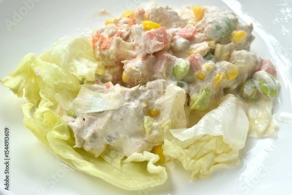 Obraz mashed tuna with corn and garden pea couple cabbage vegetable salad dressing cream sauce on plate