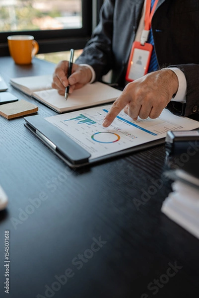Obraz an accounting and financial officer is working on documents in the office, a businessman is reviewing his company's historical budget statistics, finance, marketing