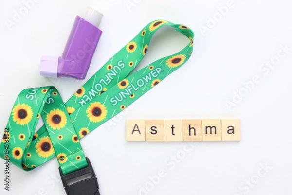 Fototapeta Hidden disability lanyard with a asthma device in a light background