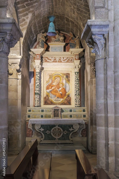Fototapeta Matera, Italy. Side altar with fresco of the Madonna and Child in the Church of San Giovanni Battista, Sassi of Matera. Decorated with angels, columns, and vivid details. Vertical image.