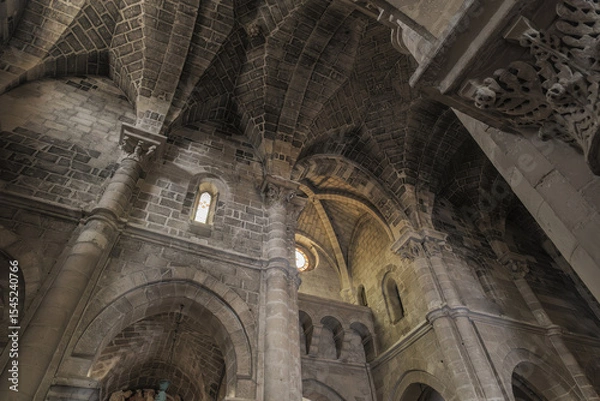 Fototapeta Matera, Italy. Vaulted ceiling and stone arches of the Church of San Giovanni Battista in the Sassi of Matera, Italy. Romanesque style with columns, capitals, and soft lighting. 