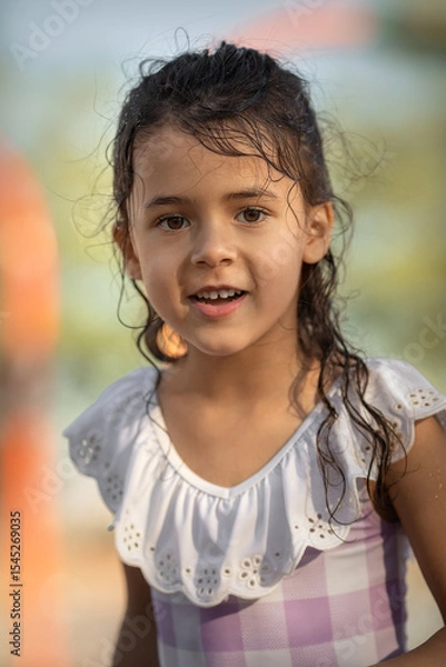 Obraz LIttle girl in swimsuit having fun in the park at summer time