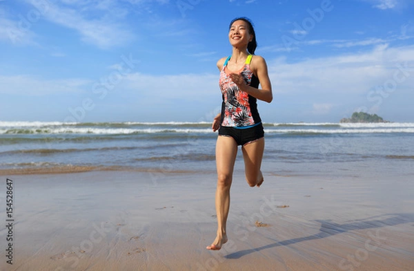 Fototapeta  young fitness woman wear swimsuit running on beach
