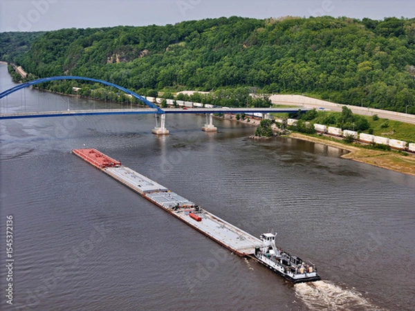 Obraz Aerial view of tug boat pushing a set of liquid cargo barges North up the Mississippi River