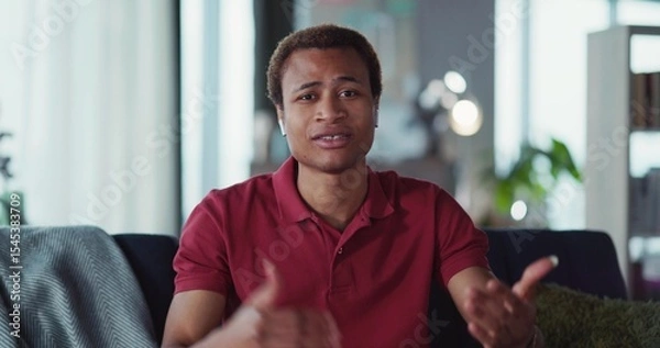 Obraz Video portrait of handsome smart african man leading online lecture webinar explaining and teaching looking into camera. Video conference. Businessman.