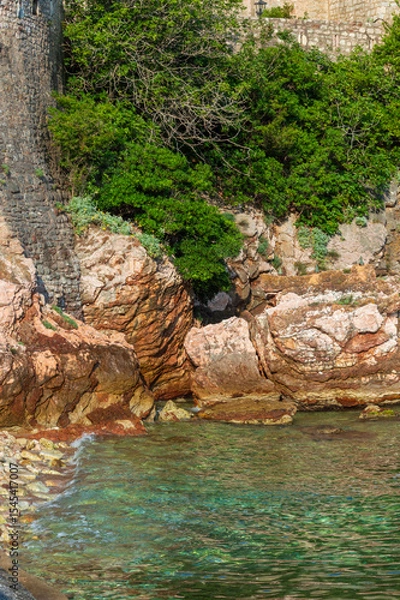 Fototapeta Rocks, stones and sea, close-up, top view. Coast of the Adriatic Sea, Montenegro. Vertical