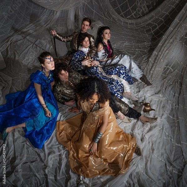 Fototapeta Oriental fantasy scene with Turkish-style dressed models in elaborate costumes, storybook atmosphere.