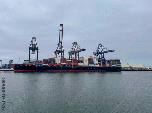Obraz Ensenada, Mexico, June 5, 2025: The Entrance to Ensenada Harbor looking at Container Cranes loading ships for sea cargo from the quayside