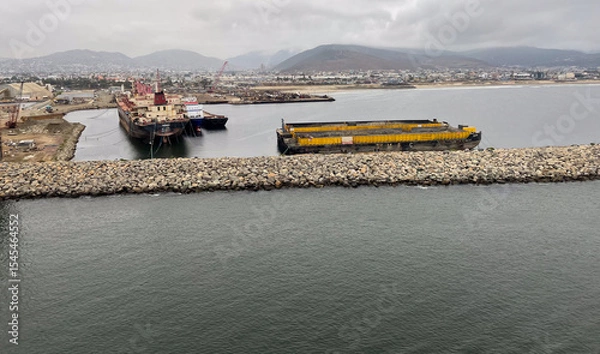 Obraz Ensenada, Mexico, June 5, 2025: The Entrance to Ensenada Harbor looking at the industrial Quay Dock where ships are repaired and anchored