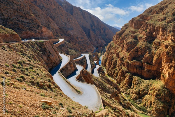 Fototapeta Winding road through a red canyon.